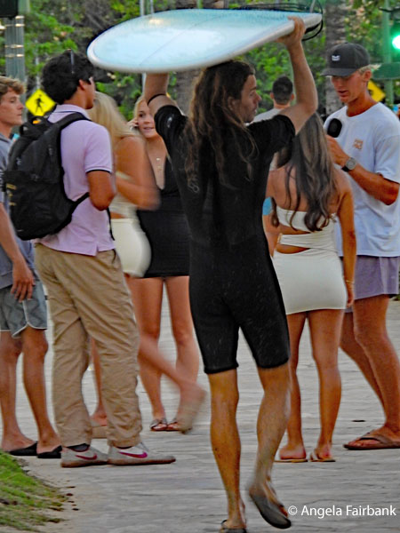 surfer with surfboard on Waikiki beach