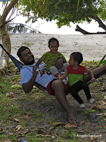 man in kids in hammock at Laura Beach