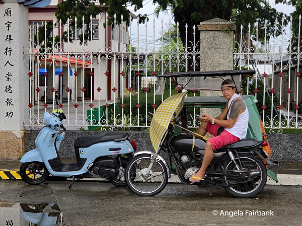 man on motorcycle in front of temple