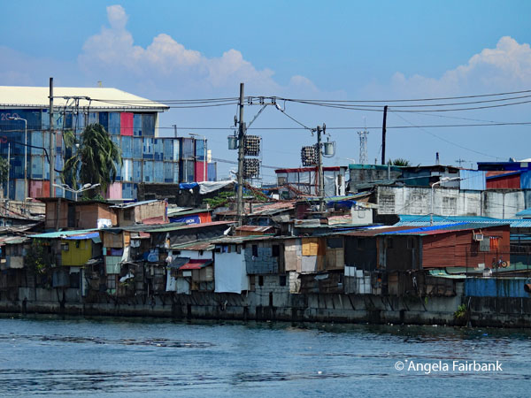 river with slum housing