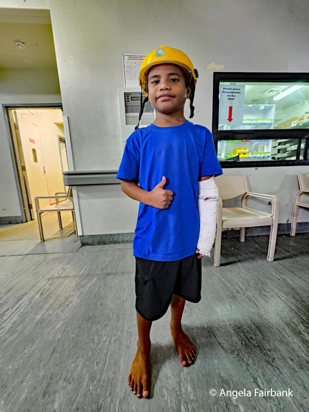 boy in Nauru flag colours at clinic
