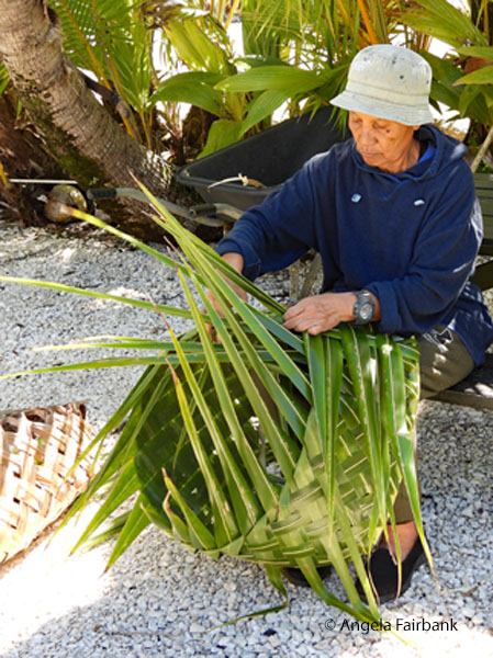 weaver weaving palm basket