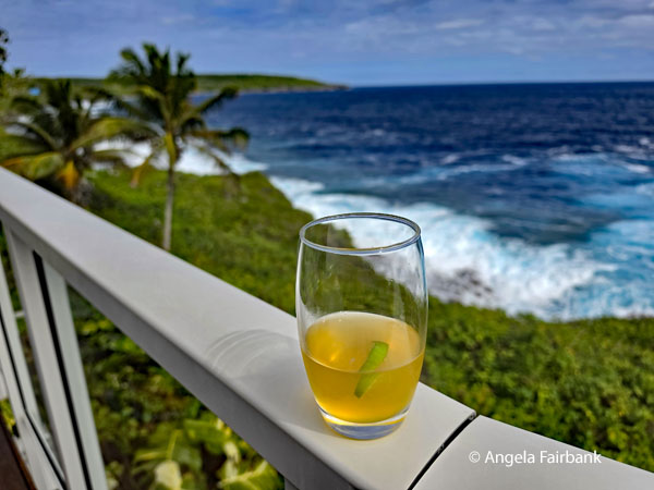 hotel welcome drink with the Pacific Ocean in the background