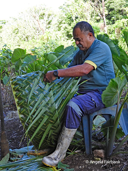 Peter weaving a palm frond basket