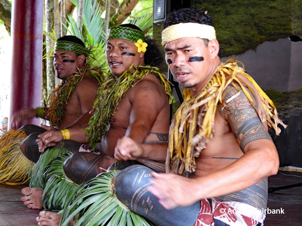 three male dancers seated