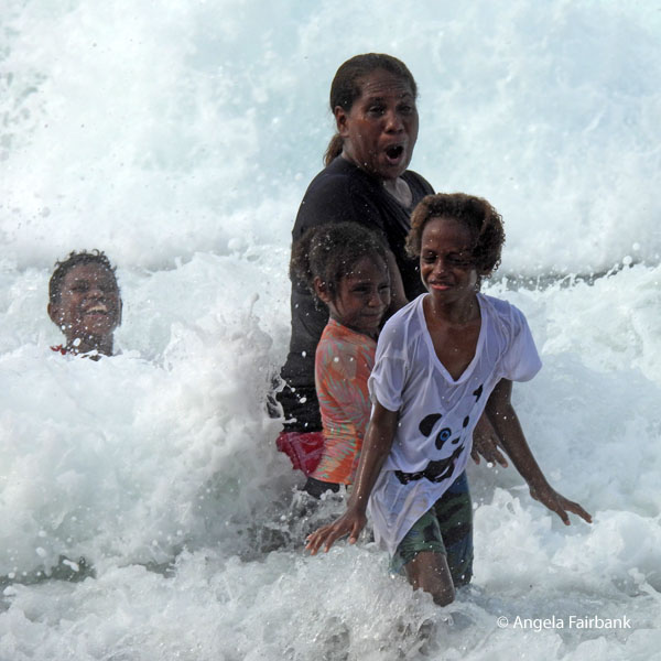 family enjoying the waves