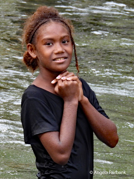 older girl in water with hands folded 1