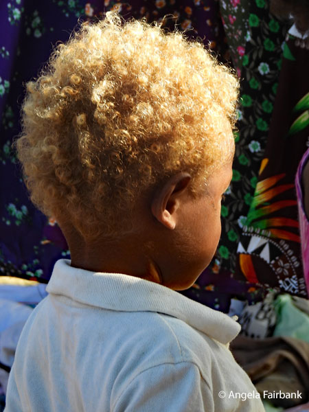 blond-haired boy at market