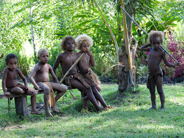 group of boys sitting and watching the dancing