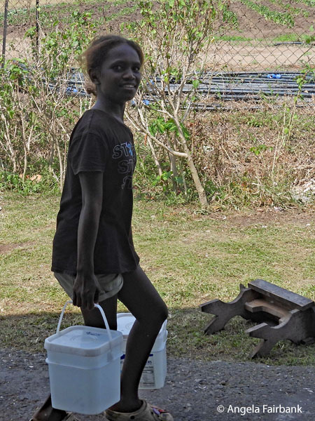 girl at war museum carrying buckets