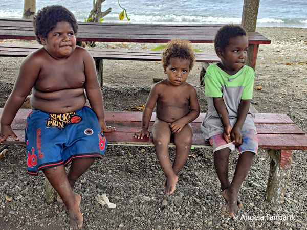 boys on bench at beach