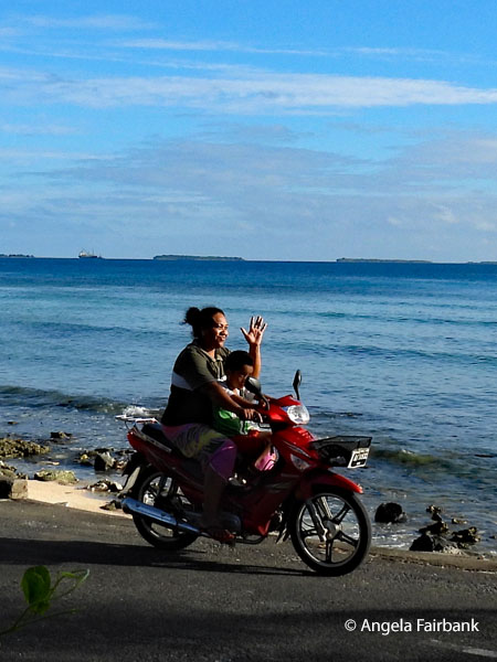 mother and son on motorbike