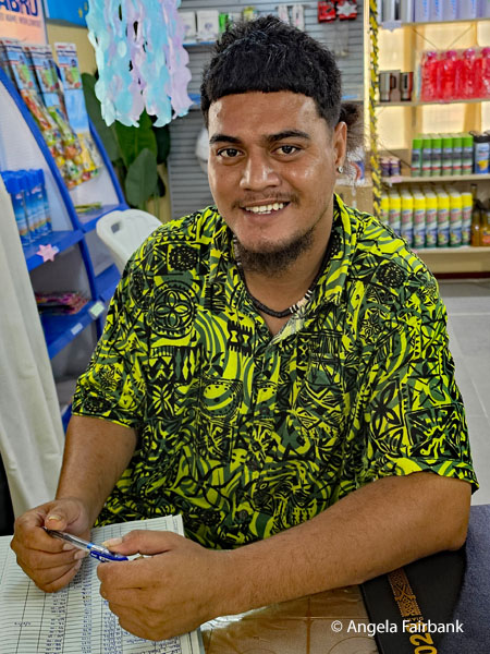 Vendor at souvenir store behind post office