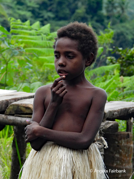 young girl in grass skirt