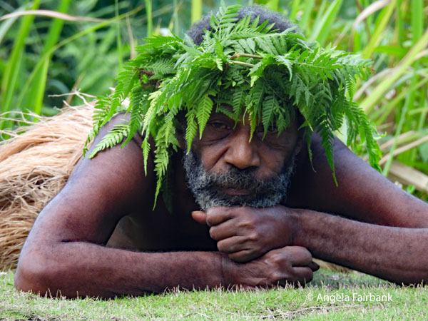man lying on ground with head on fists
