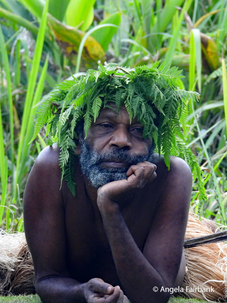 man lying on grond with chin in hand