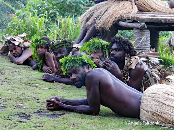 row of men lying down and watching