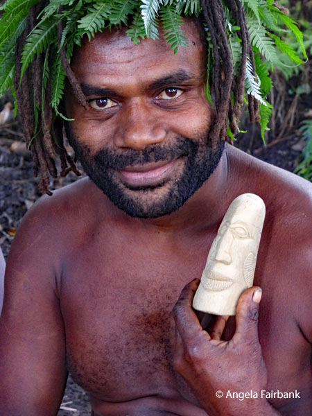 artist holding the carved stone head I bought