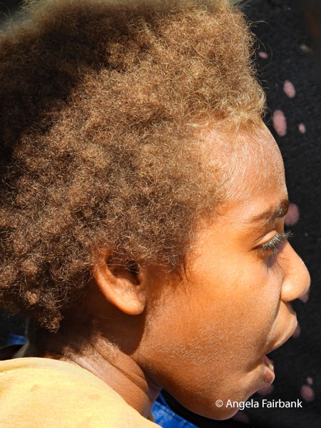 side view of boy in yellow t-shirt