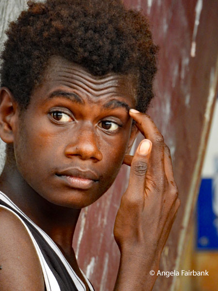 boy with finger to eyebrow