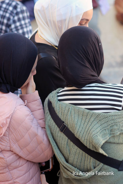 three young women looking at phone