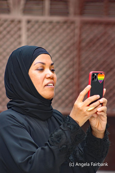 a female tour guide taking a photo with her phone