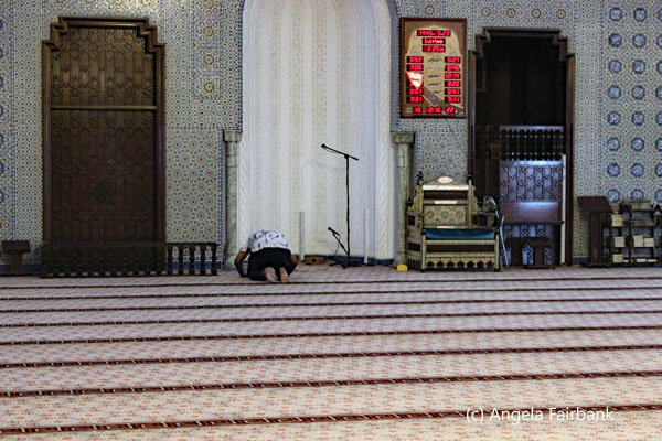 man praying in enany mosque