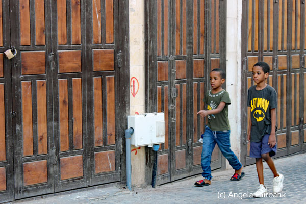 two boys walking in al balad