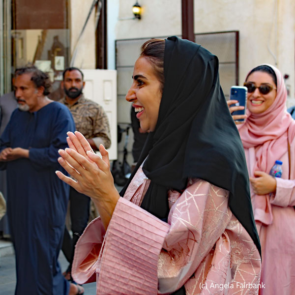 women in pink smiling and clapping