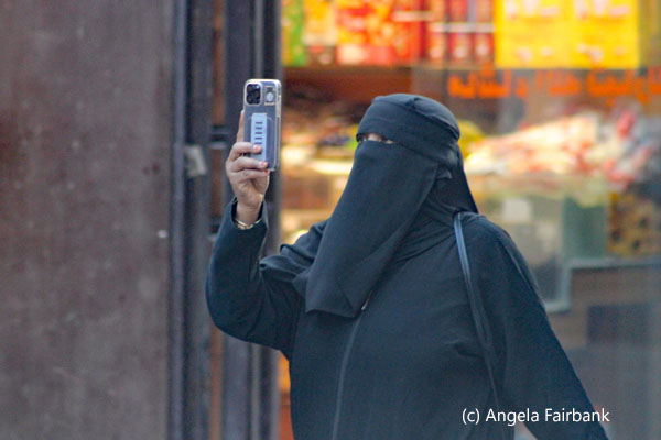 woman in black using video on phone