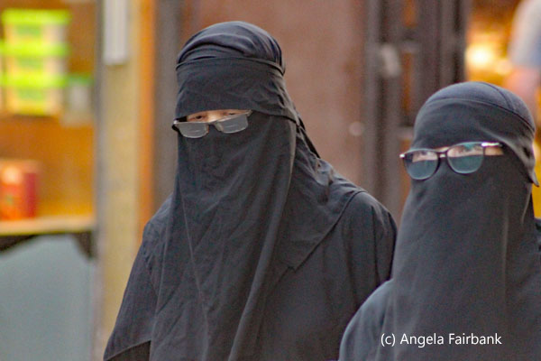 two women in black in glasses