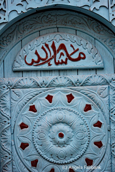 blue door with calligraphy