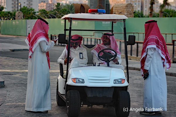 four men and golf cart