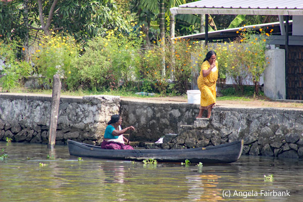 woman in boat talking to other womangoing up stairs