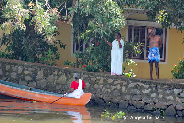 couple chatting to woman in boat