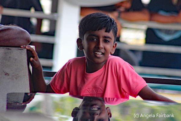boy in boat with mirror image
