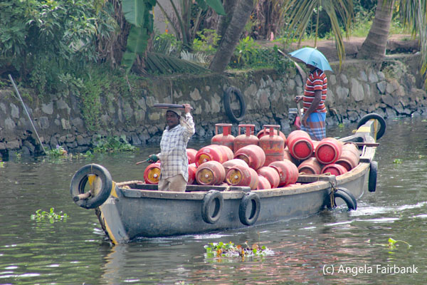 2 men in boat with barrels
