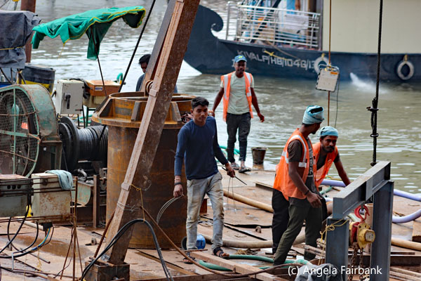 men working on dredger