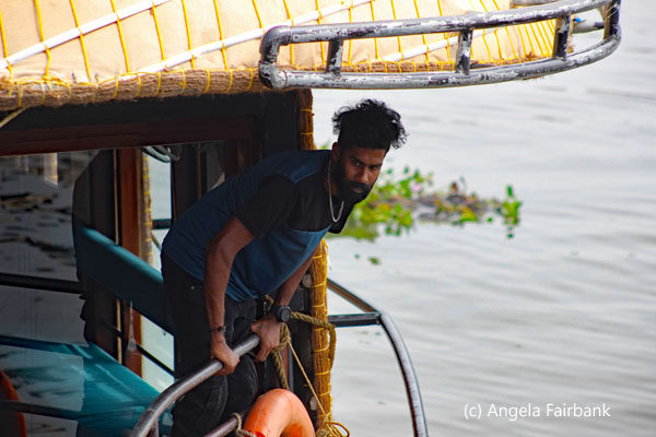 young man leaning out of houseboat