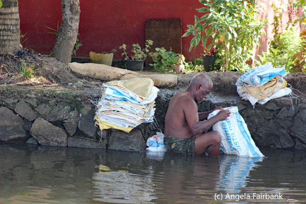 man washing bags