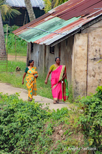 2 woman walking by house