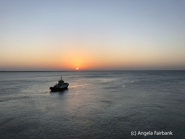 sunrise with tug boat