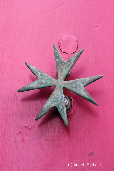 Maltese cross on door