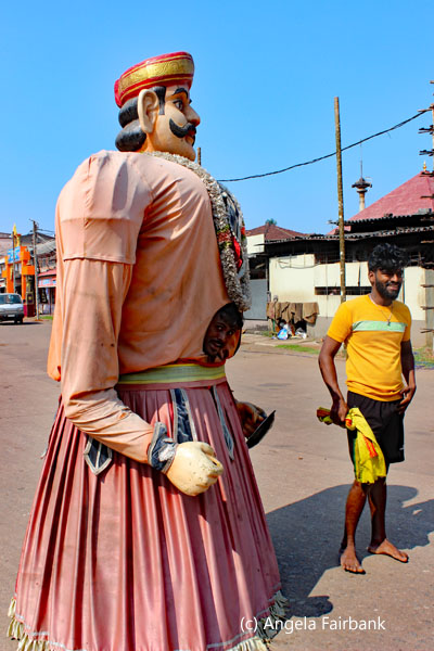 man inside huge male effigy