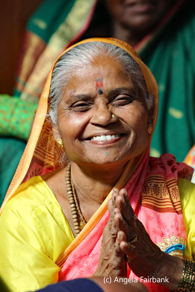 woman in yellow smiling