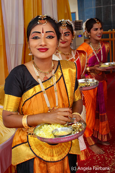 ladies at welcome putting on tika