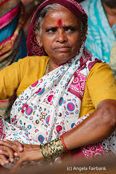 woman in yellow with grey hair
