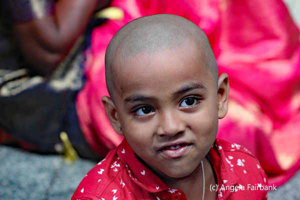 bald child in red
