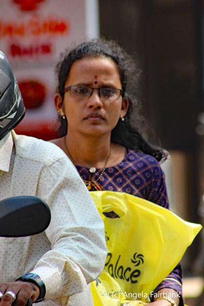 young woman on back of motorbike