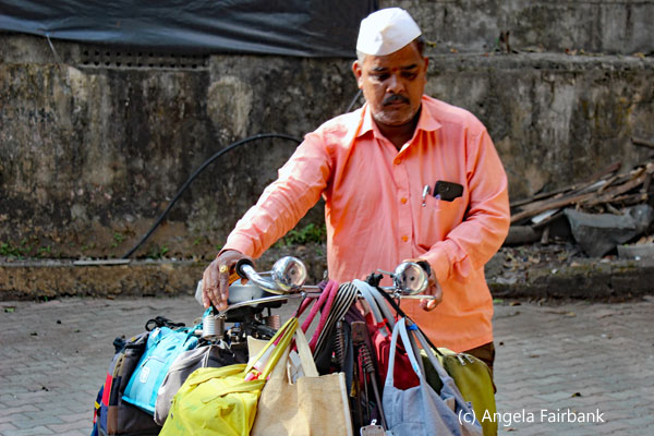 dabbawala carrying bags on bike